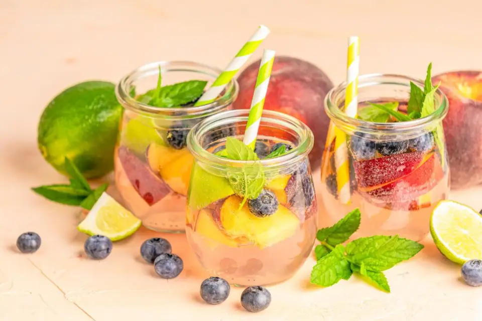 Assortment of detox drinks including green tea, lemon water, apple cider vinegar drink, ginger tea, and detox water.