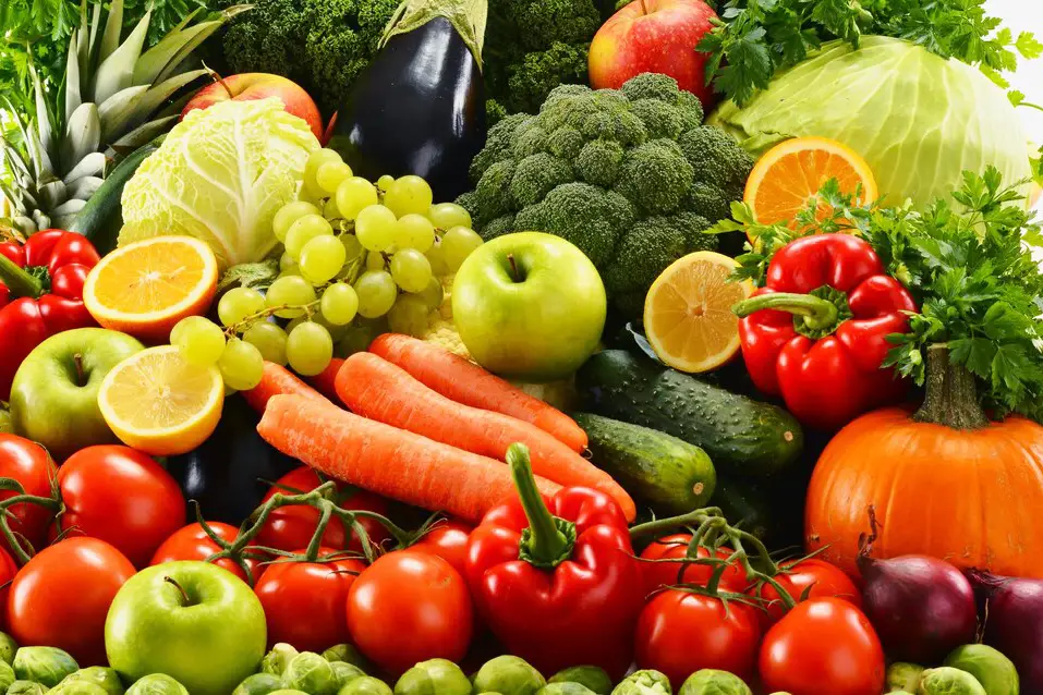 Image showing a variety of colorful fruits and vegetables, including berries, bananas, apples, leafy greens, and cruciferous vegetables, which are beneficial for a weight gain diet.