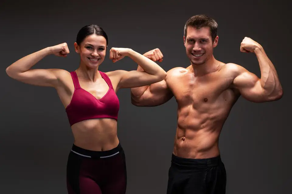 Man and woman performing weight loss exercises in a gym, focusing on different workout routines to reach fitness goals.