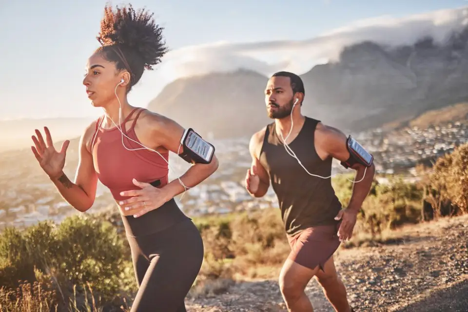 A captivating image featuring a man and woman jogging against a backdrop of scenic mountains, epitomizing the concept of healthy living by embracing an active lifestyle.