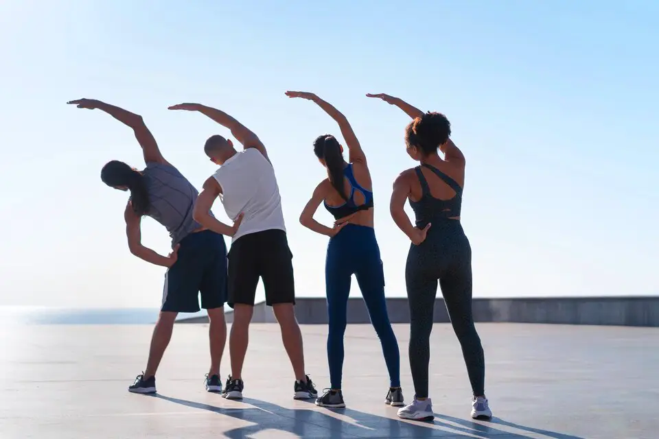 Group of people exercising outdoors, demonstrating effective fitness routines for all age groups.